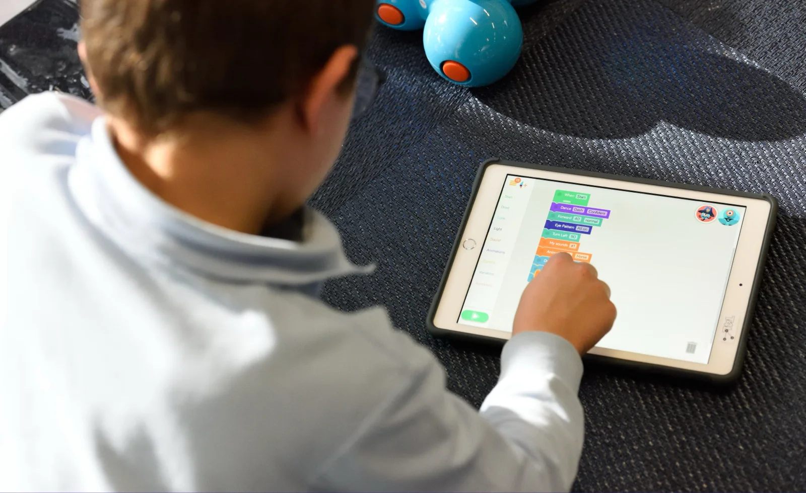 A kid playing a educational game on tablet